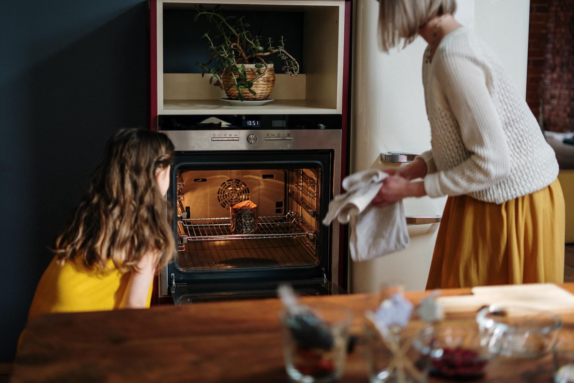 Family cooking meal in Altus oven