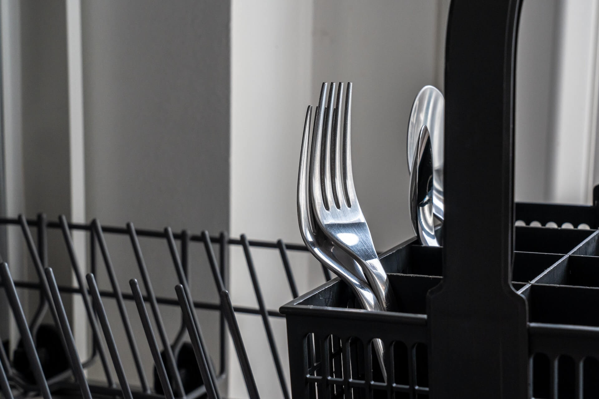 Cutlery placed inside a dishwasher